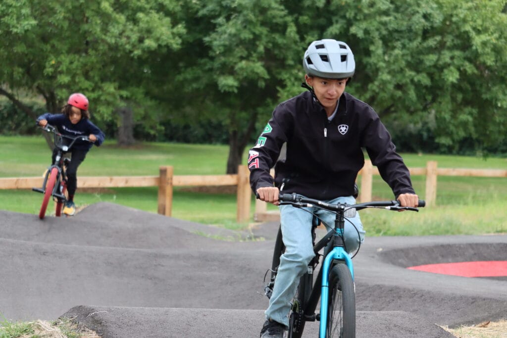 Child riding a bike at the Montbello Pump Track in Denver.
